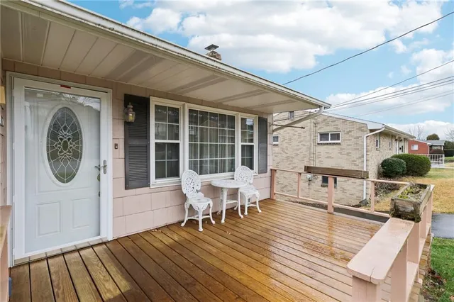 a balcony with furniture and wooden floor