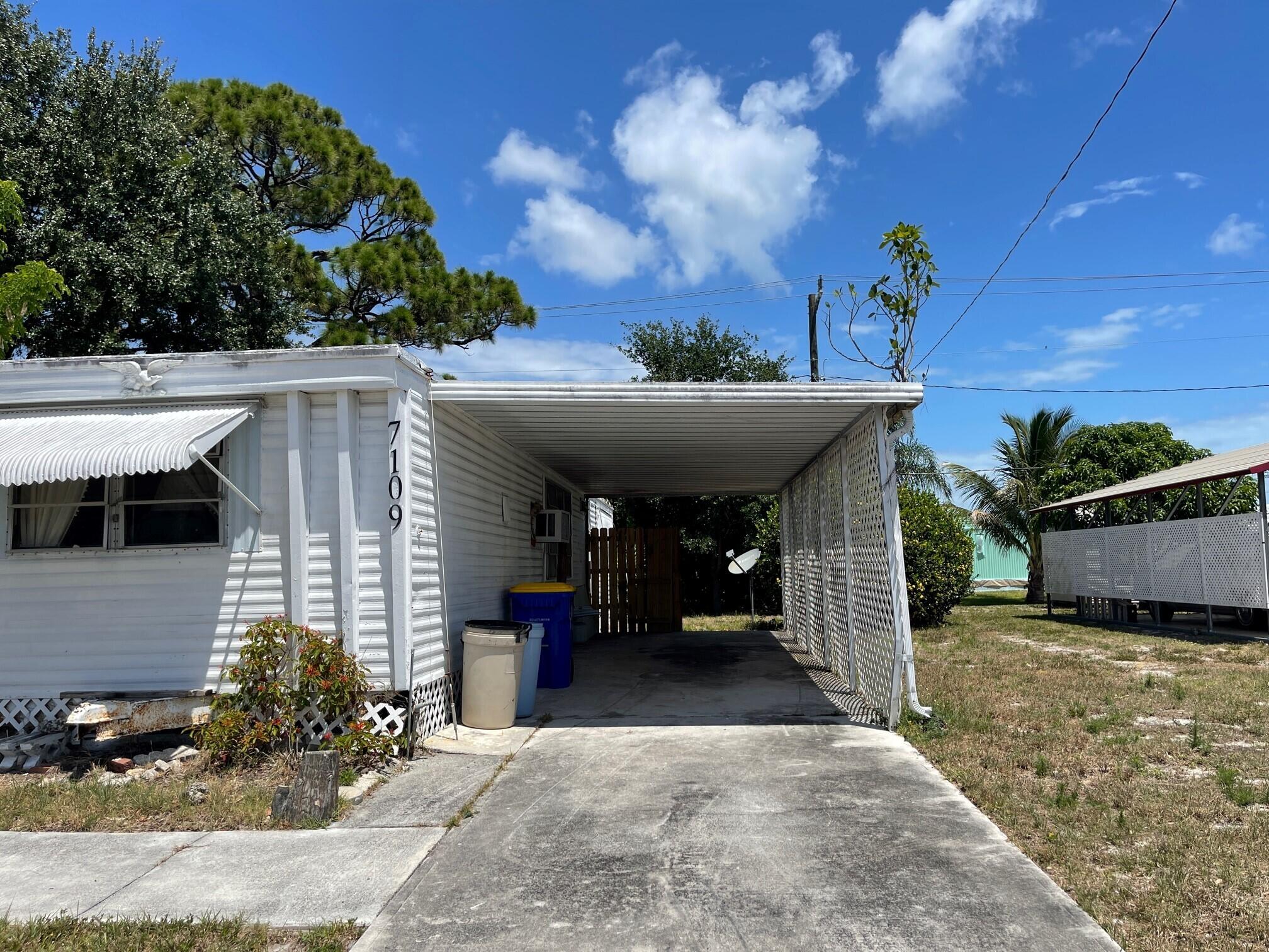7109 Southeast Ridgeway Terrace Hobe Sound, FL 33455 - Photo 3 of 11 Carport