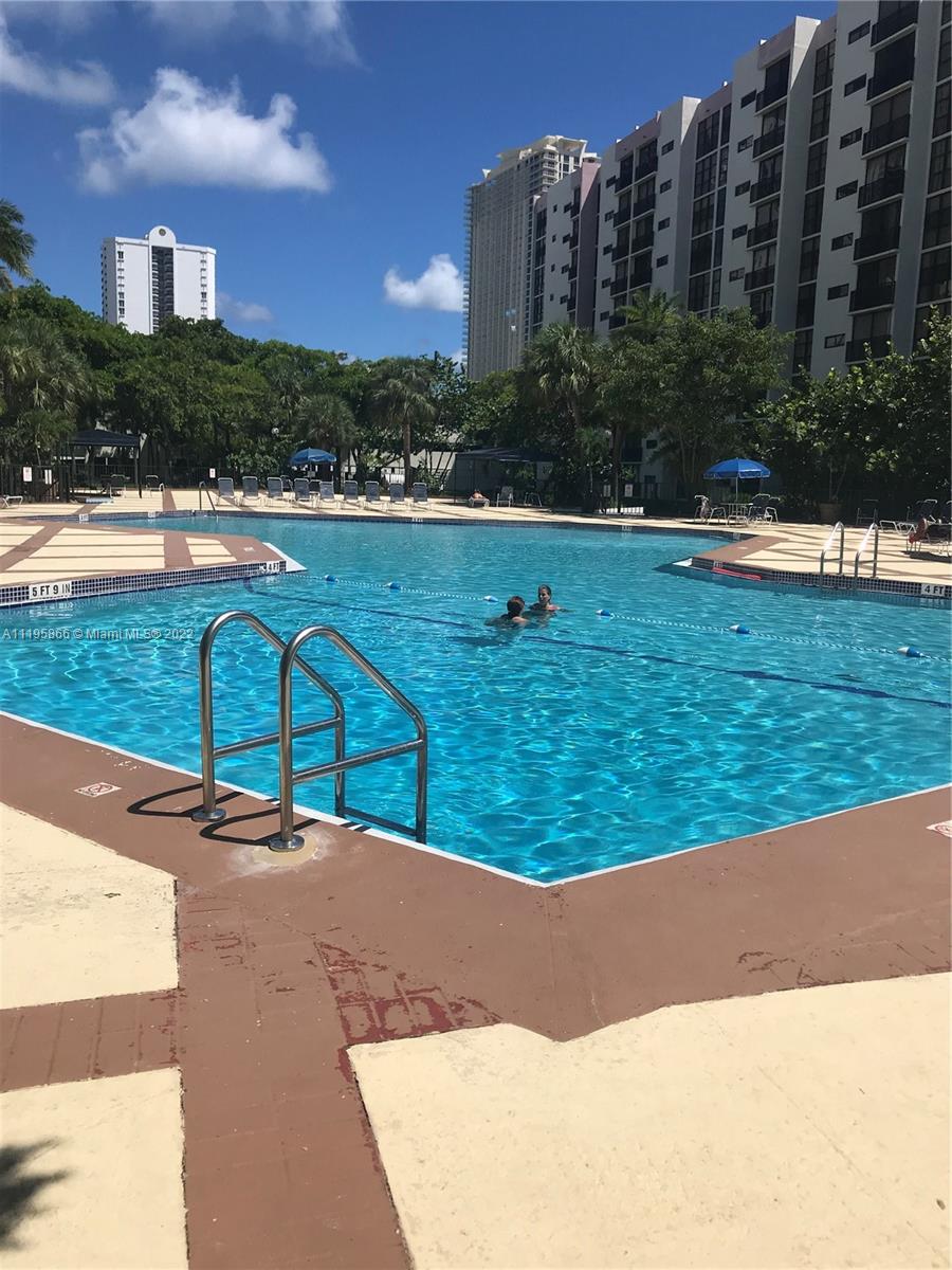 17021 North Bay Road, Unit 1005 Sunny Isles Beach, FL 33160 - Photo 2 of 7 a view of a swimming pool with a yard