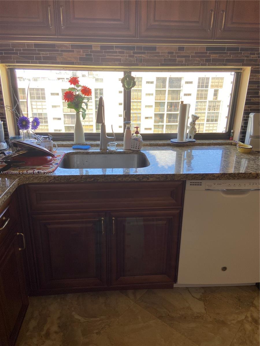 17021 North Bay Road, Unit 1005 Sunny Isles Beach, FL 33160 - Photo 4 of 7 a kitchen with a sink and large window