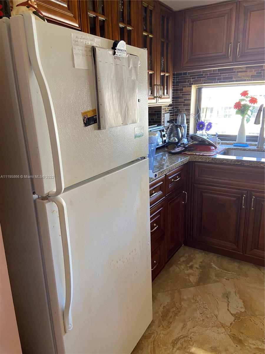 17021 North Bay Road, Unit 1005 Sunny Isles Beach, FL 33160 - Photo 5 of 7 a kitchen with stainless steel appliances a refrigerator and a sink