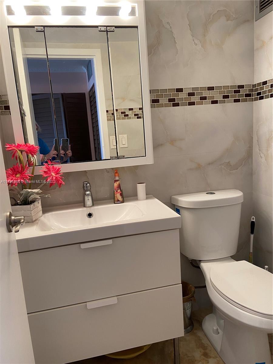 17021 North Bay Road, Unit 1005 Sunny Isles Beach, FL 33160 - Photo 7 of 7 a bathroom with a sink and a mirror