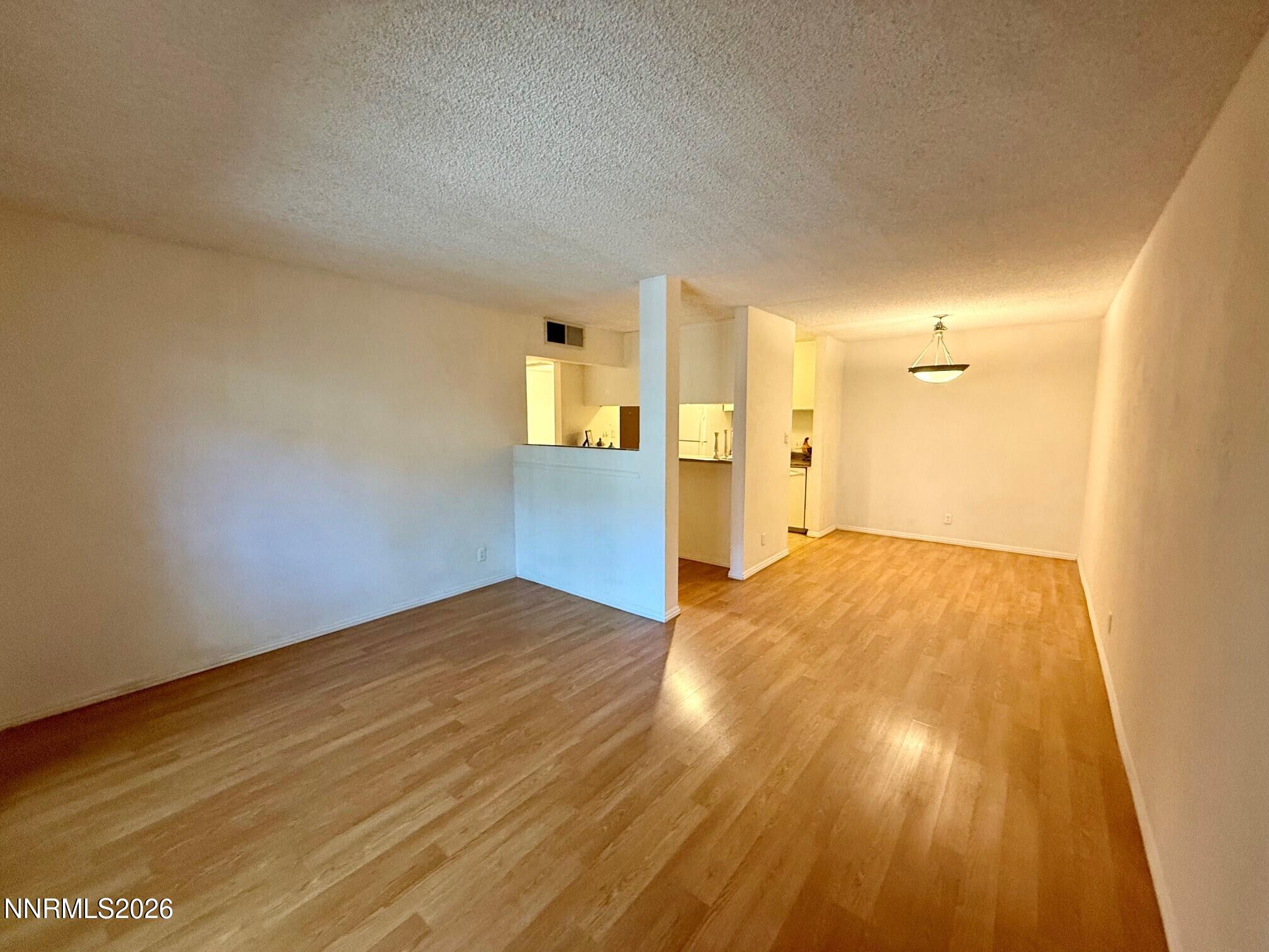2955 Lakeside Drive, Unit 120 Reno, NV 89509 - Photo 3 of 21 a view of empty room with wooden floor
