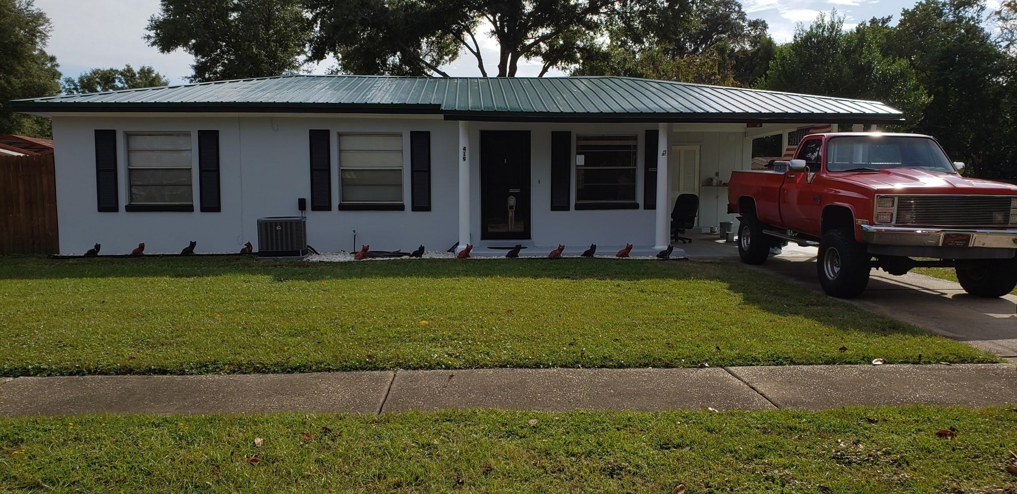 a front view of a house with a garden
