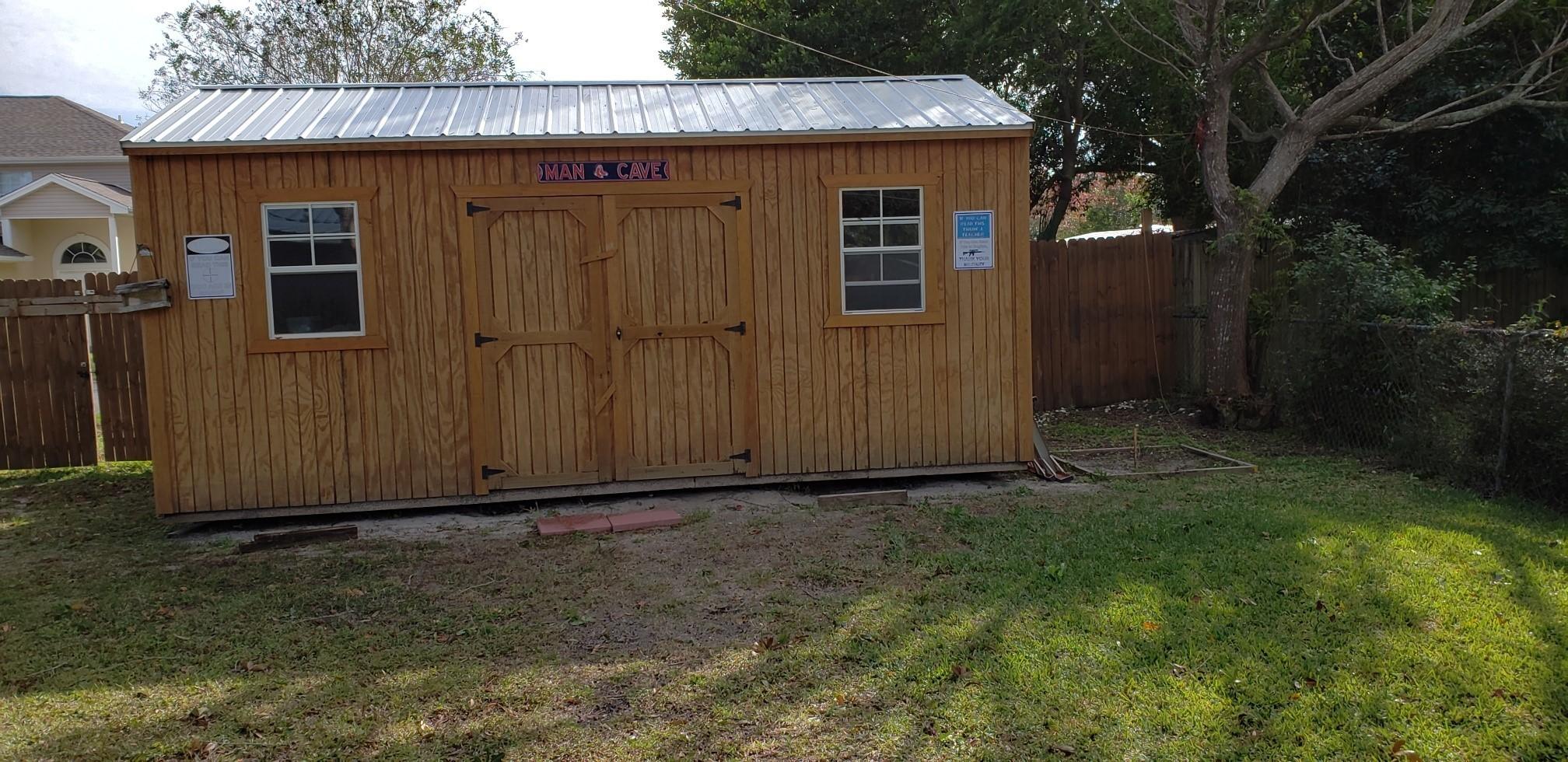 419 Marlowe Drive Fort Walton Beach, FL 32547 - Photo 3 of 12 a view of backyard with potted plants wooden fence and large trees