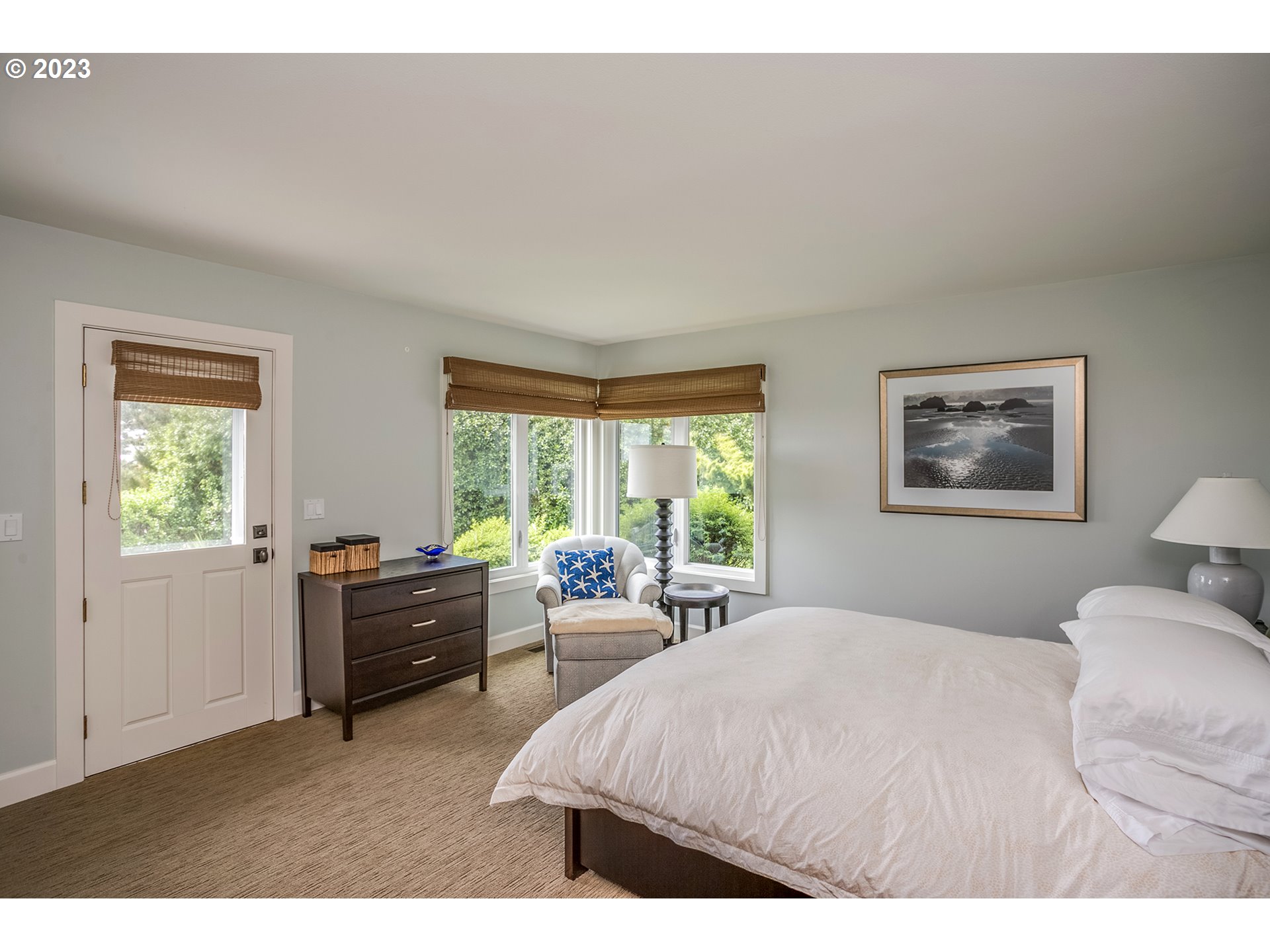 4710 High Ridge Road Gearhart, OR 97138 - Photo 19 of 44 a bedroom with a bed and a large window