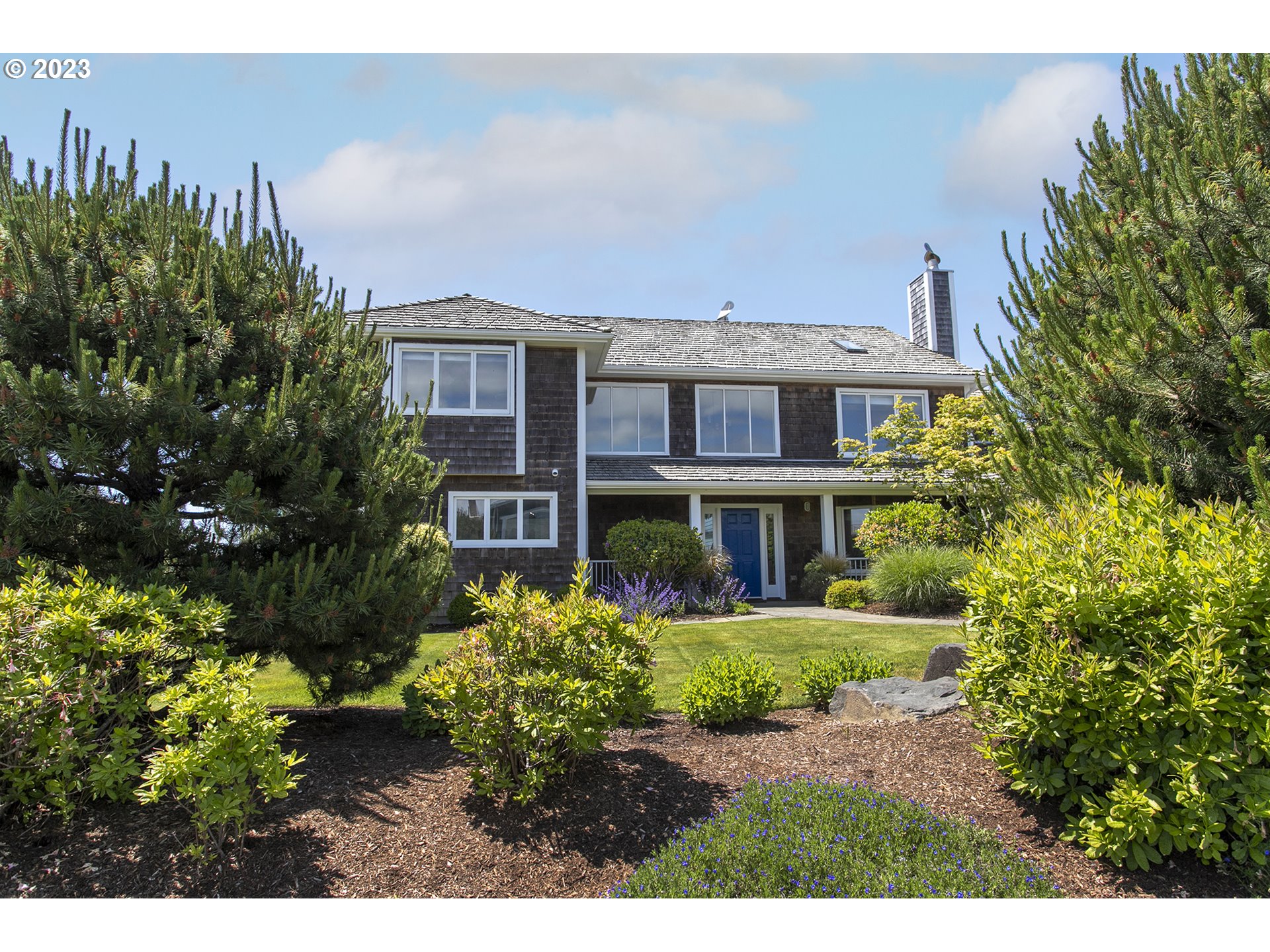 4710 High Ridge Road Gearhart, OR 97138 - Photo 3 of 44 a front view of a house with a garden
