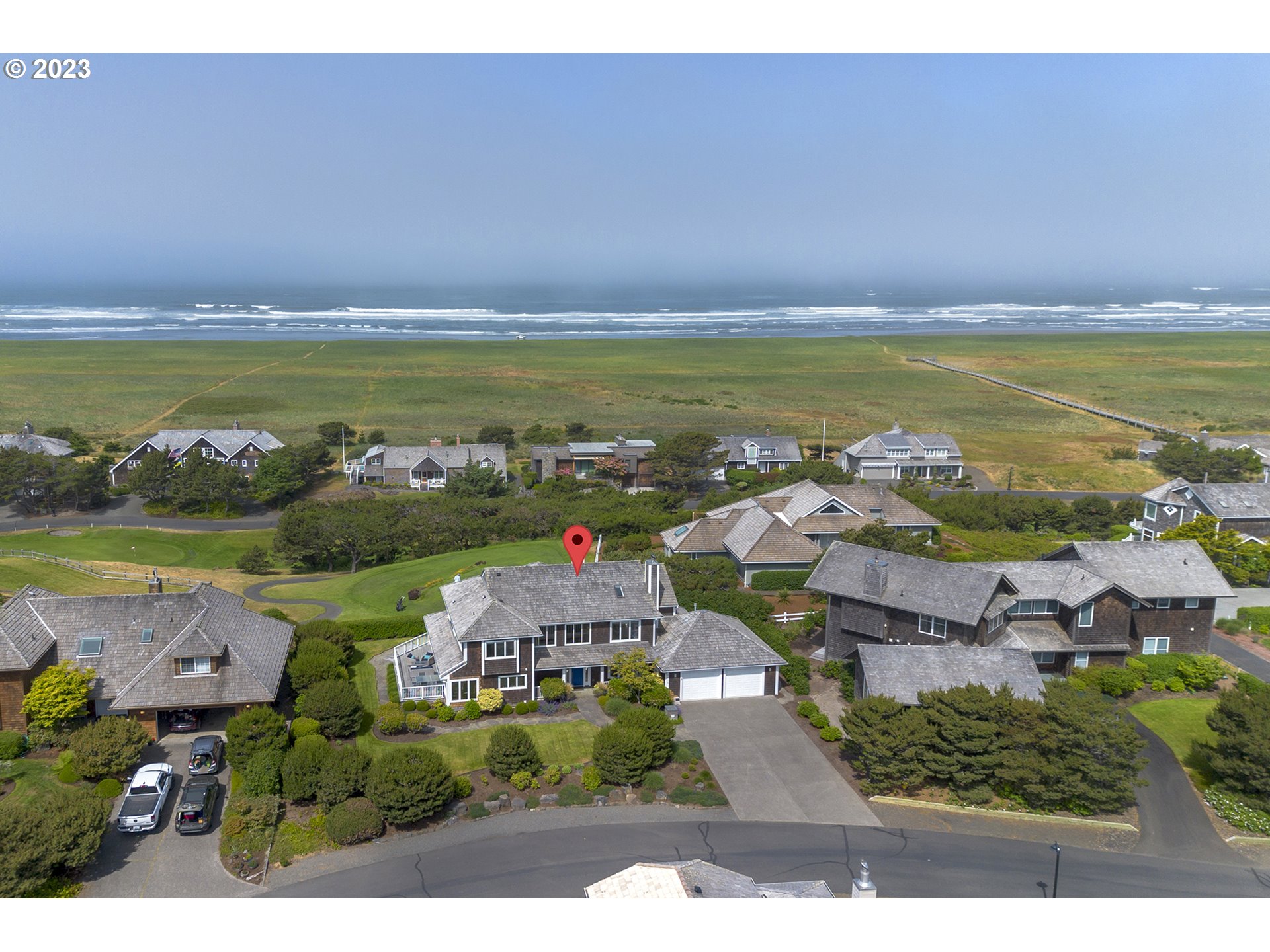 4710 High Ridge Road Gearhart, OR 97138 - Photo 40 of 44 a view of an ocean with a building in the background