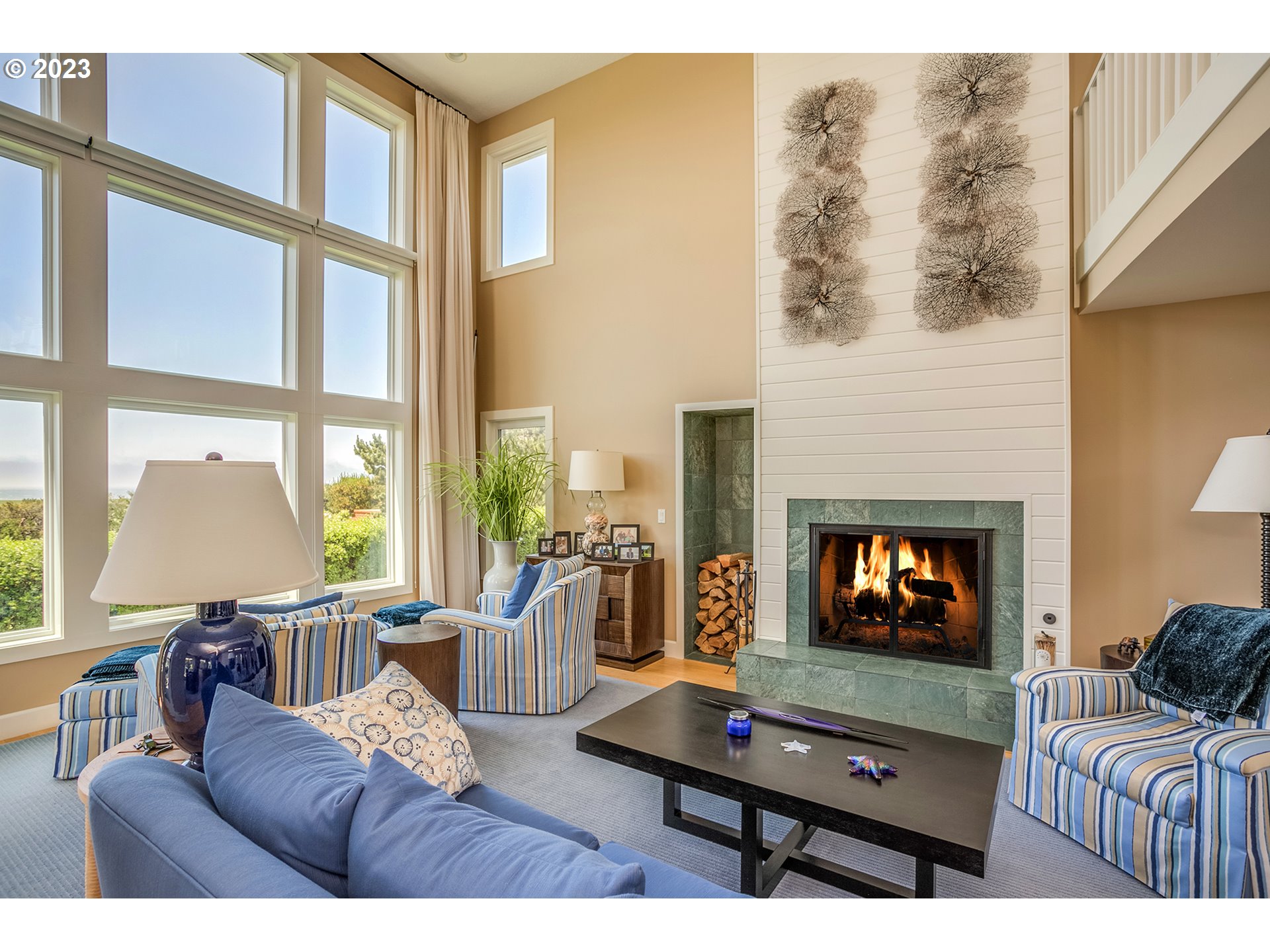 4710 High Ridge Road Gearhart, OR 97138 - Photo 9 of 44 a living room with furniture a flat screen tv and a floor to ceiling window