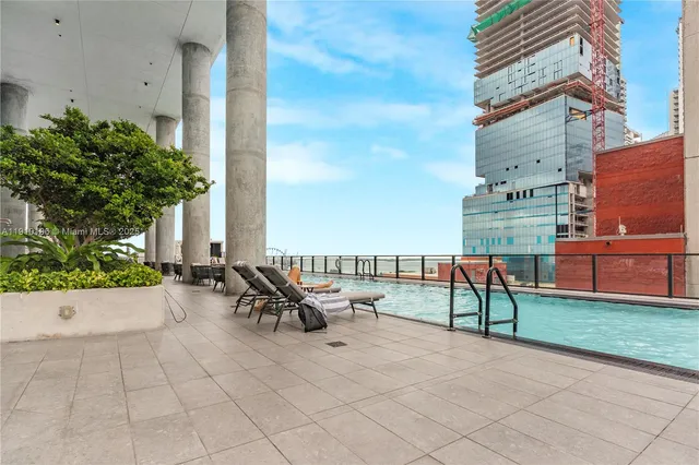 a view of a room with gym equipment and large windows
