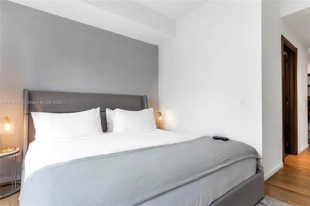 a large bed sitting in a bedroom next to a window