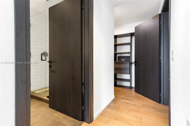 a view of a hallway with wooden shelves