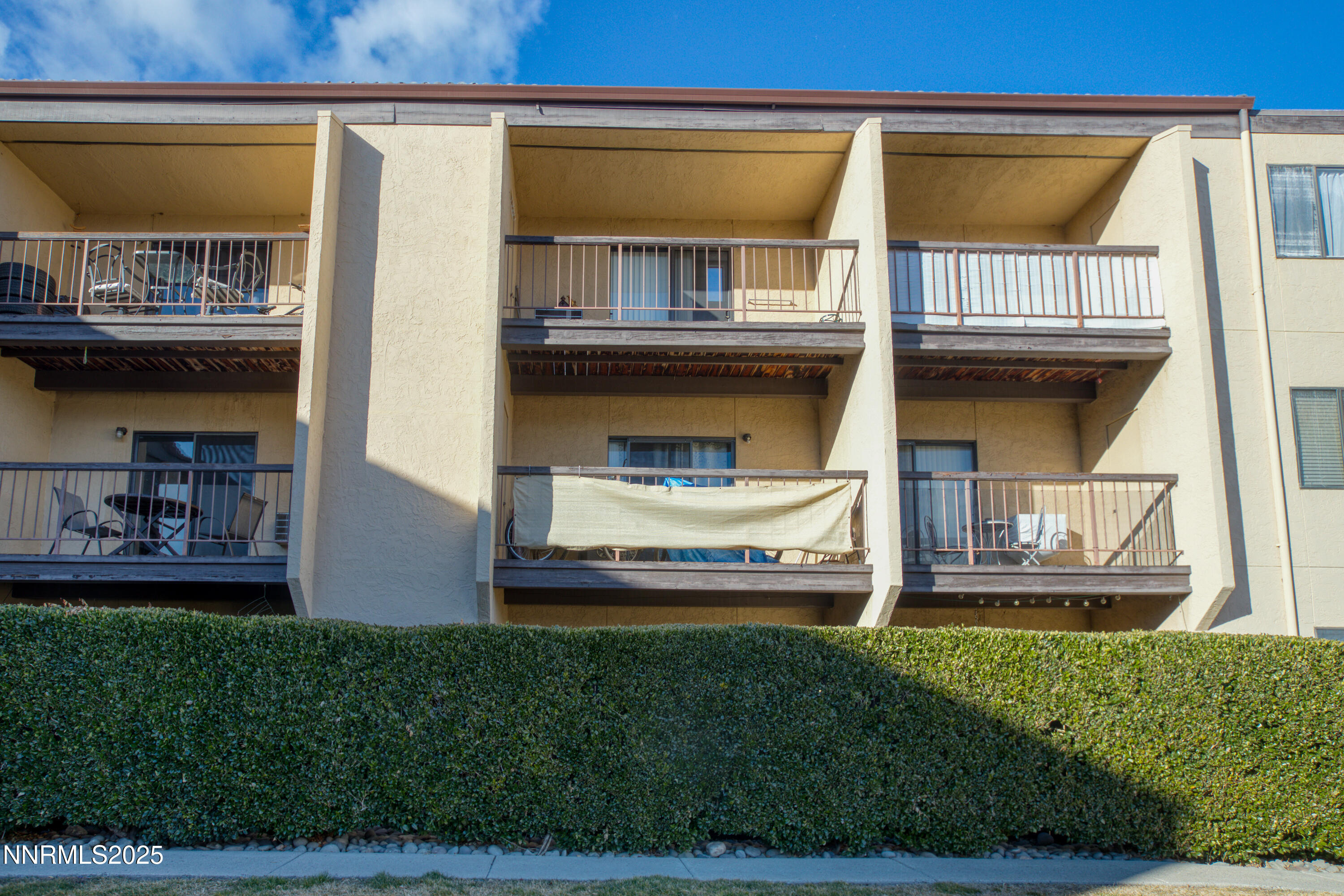 2450 Lymbery Street, Unit 213 Reno, NV 89509 - Photo 3 of 25 a front view of a house with a garden