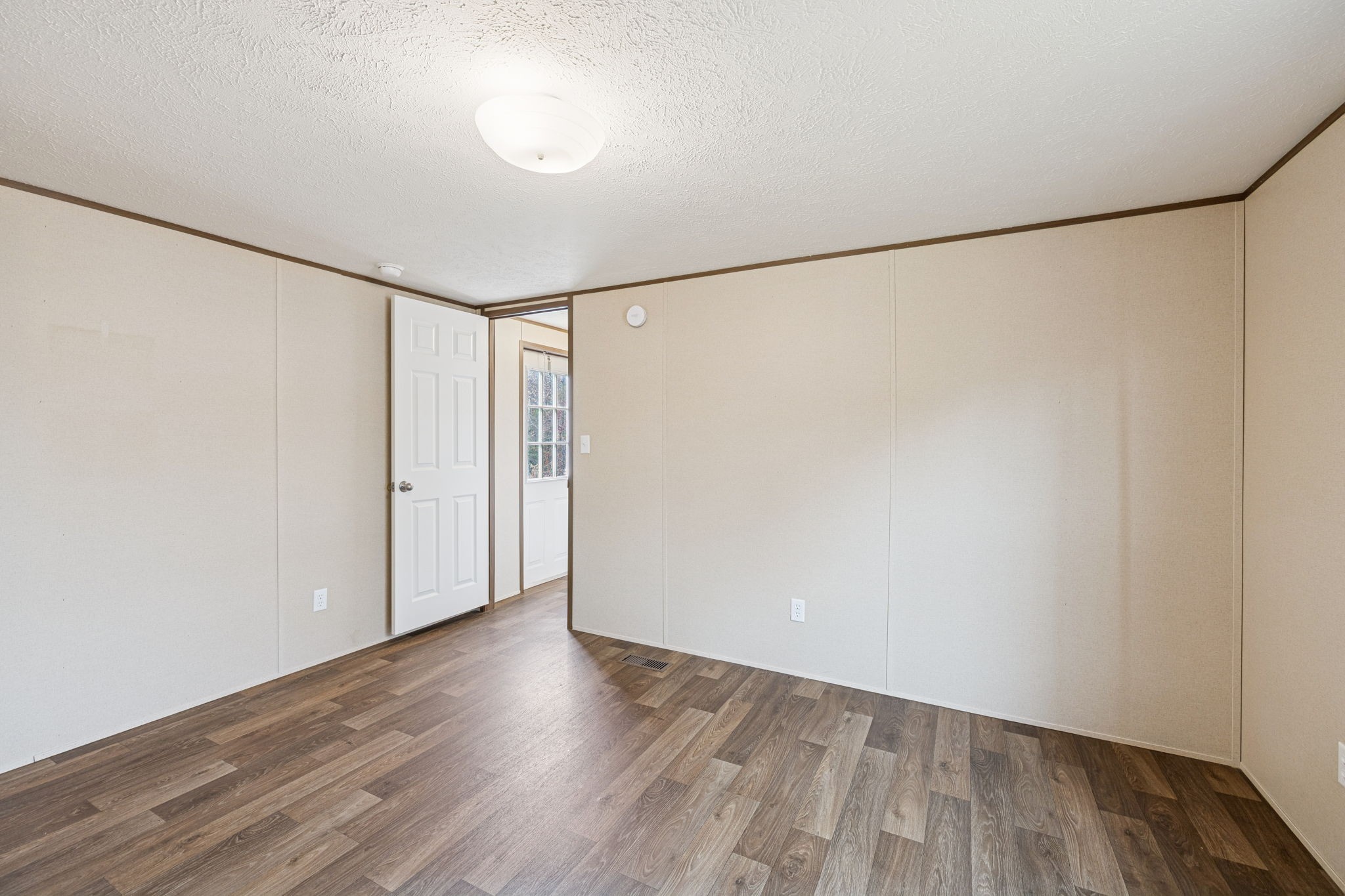 108 Lyell Road Hohenwald, TN 38462 - Photo 11 of 25 a view of an empty room with wooden floor
