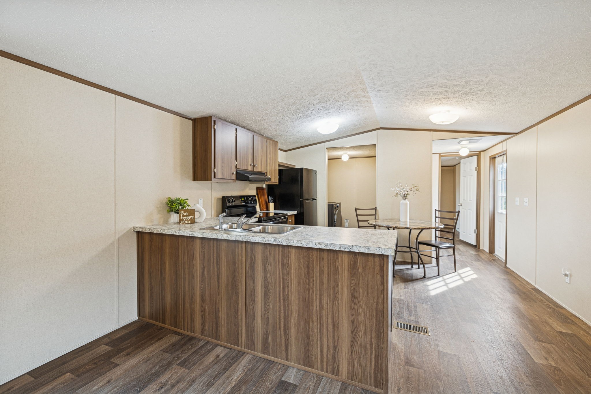 108 Lyell Road Hohenwald, TN 38462 - Photo 6 of 25 a kitchen with stainless steel appliances granite countertop a refrigerator a sink dishwasher a stove with wooden cabinets and wooden floor