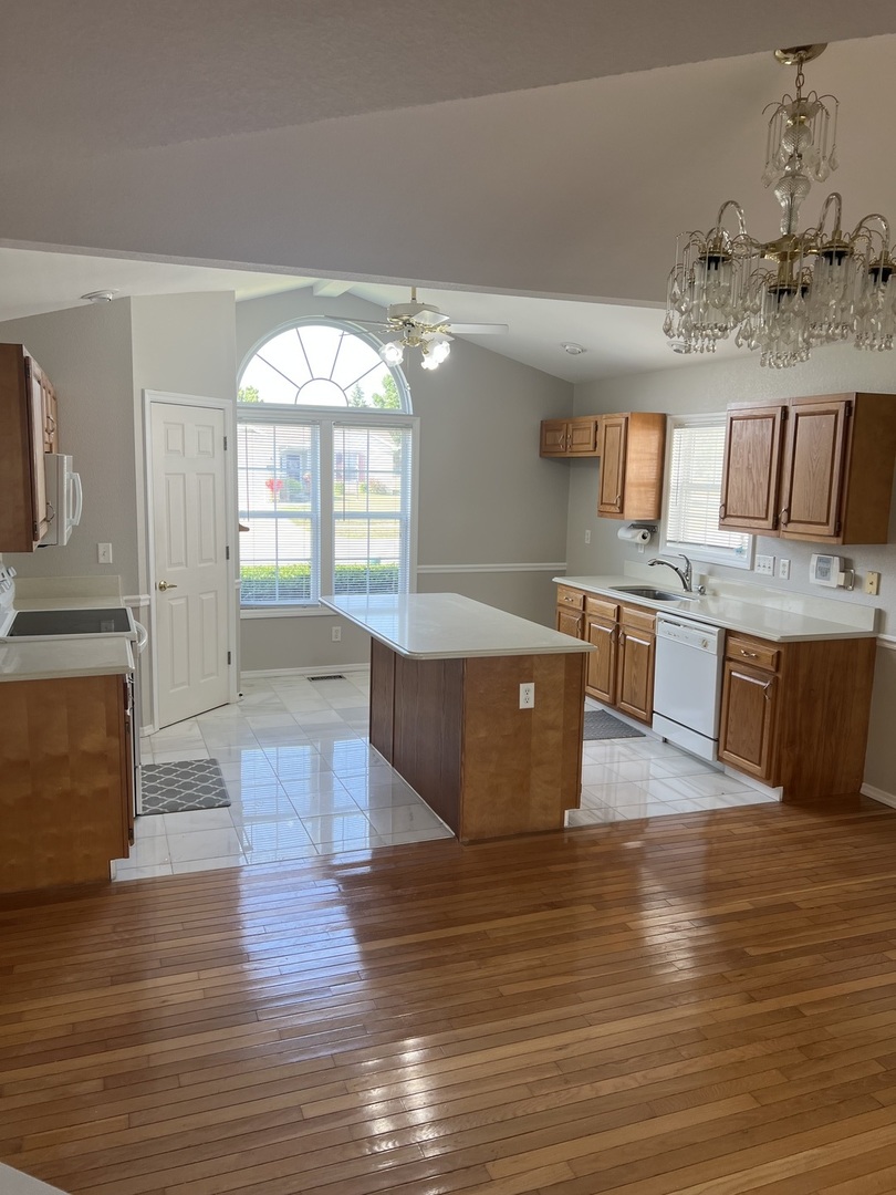3123 Brookstone Danville, IL 61832 - Photo 3 of 20 a living room with kitchen island granite countertop wooden floor and a fireplace