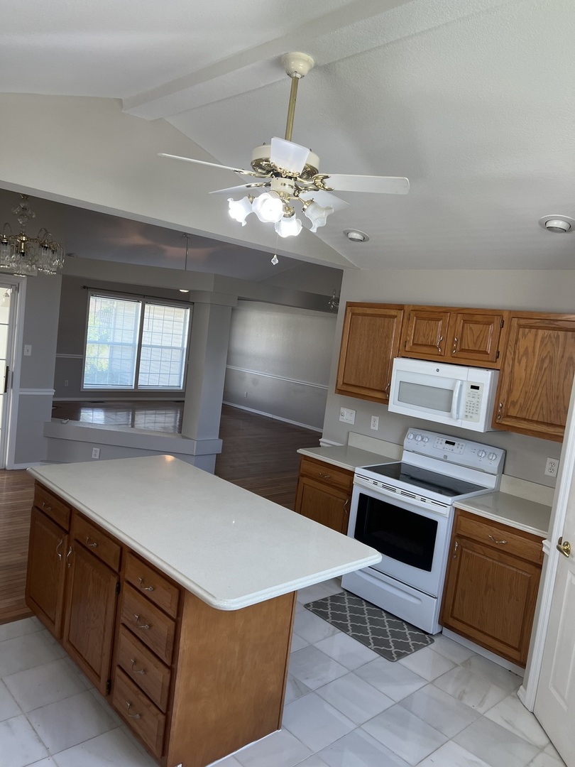3123 Brookstone Danville, IL 61832 - Photo 7 of 20 a living room with stainless steel appliances furniture a chandelier and a large window