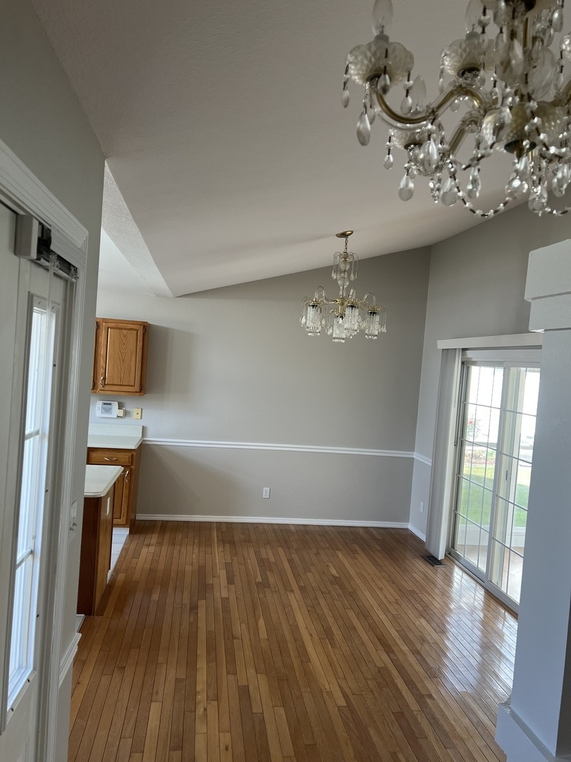 3123 Brookstone Danville, IL 61832 - Photo 9 of 20 wooden floor in an empty room with a window