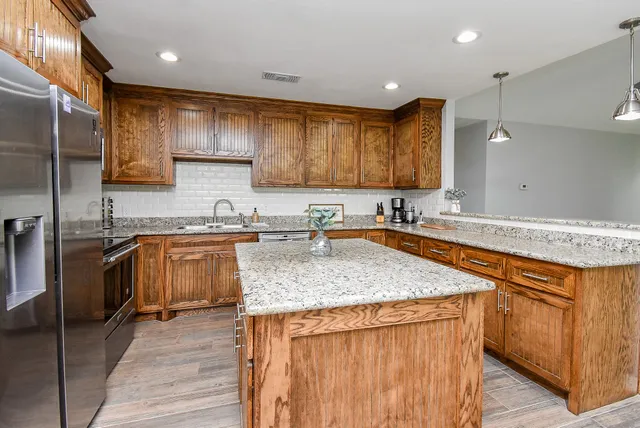 a kitchen with a sink and wooden cabinets