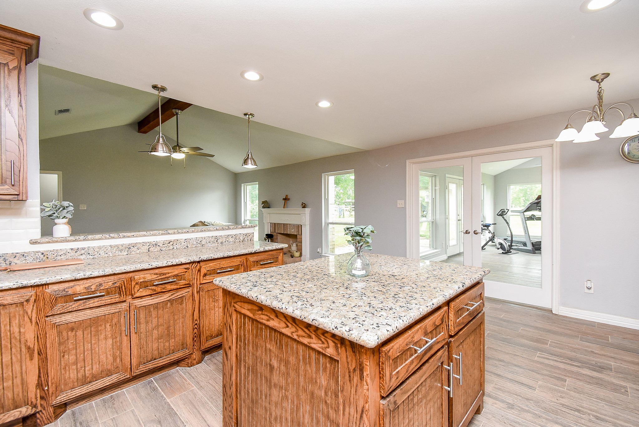 3818 County Road 36 Angleton, TX 77515 - Photo 11 of 49 a kitchen with granite countertop kitchen island sink refrigerator and wooden floor