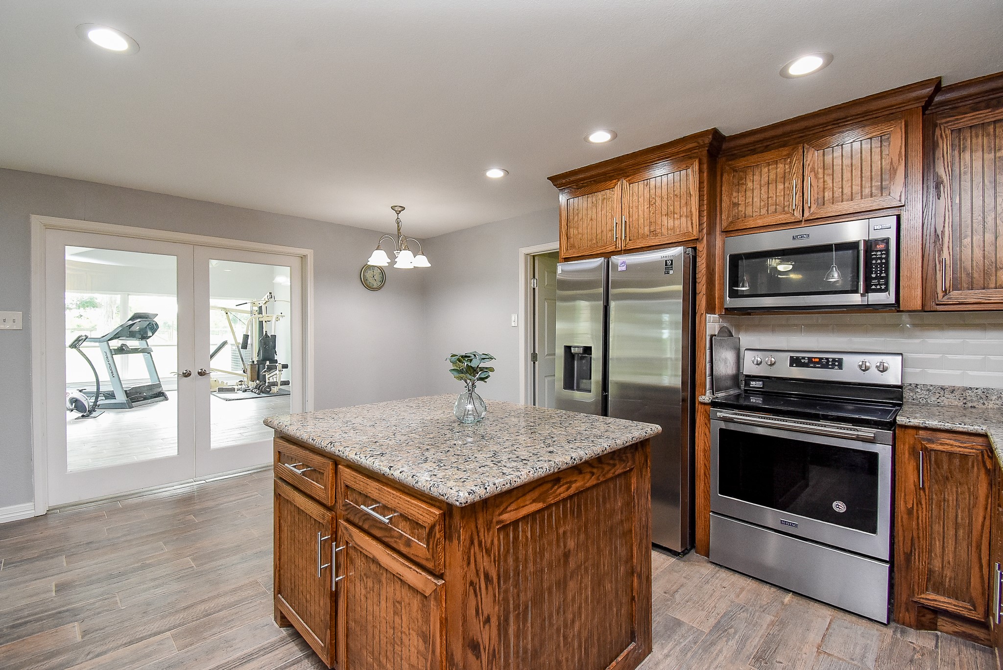 3818 County Road 36 Angleton, TX 77515 - Photo 12 of 49 a kitchen with stainless steel appliances granite countertop a kitchen island hardwood floor sink stove and granite counter top