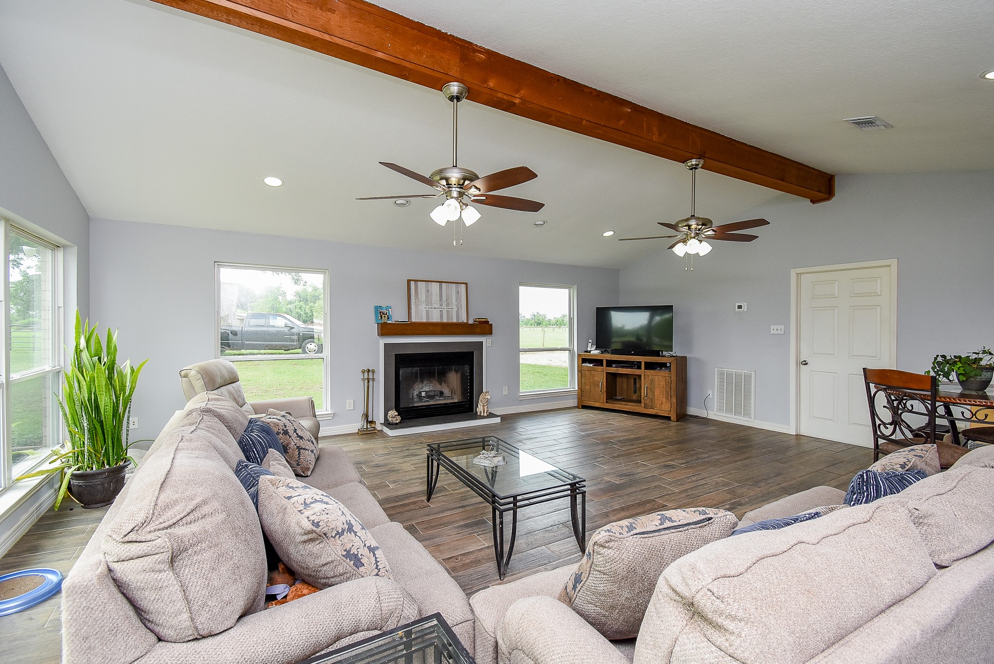 3818 County Road 36 Angleton, TX 77515 - Photo 21 of 49 a living room with furniture a fireplace and a flat screen tv