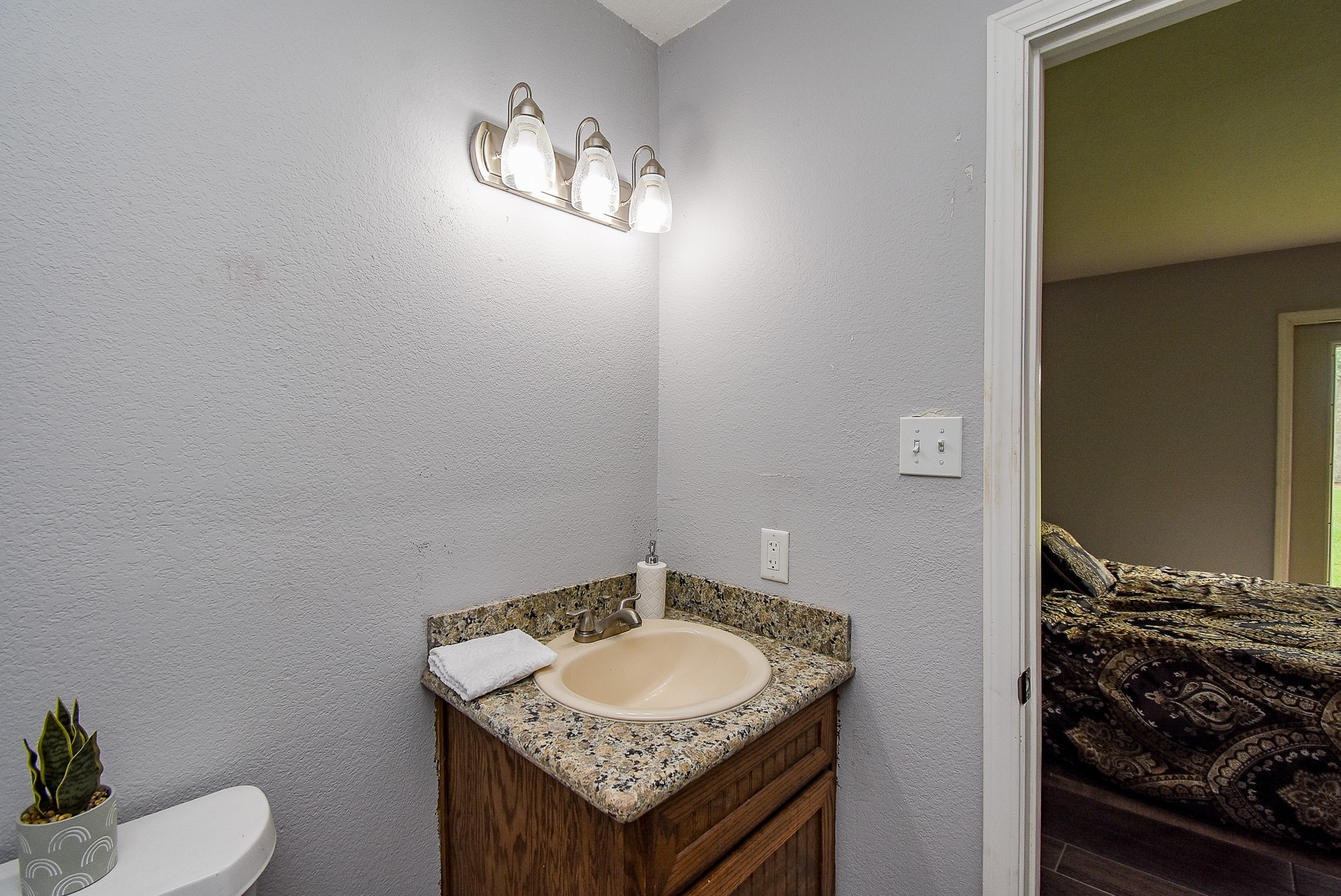 3818 County Road 36 Angleton, TX 77515 - Photo 28 of 49 a bathroom with a granite countertop sink and a mirror