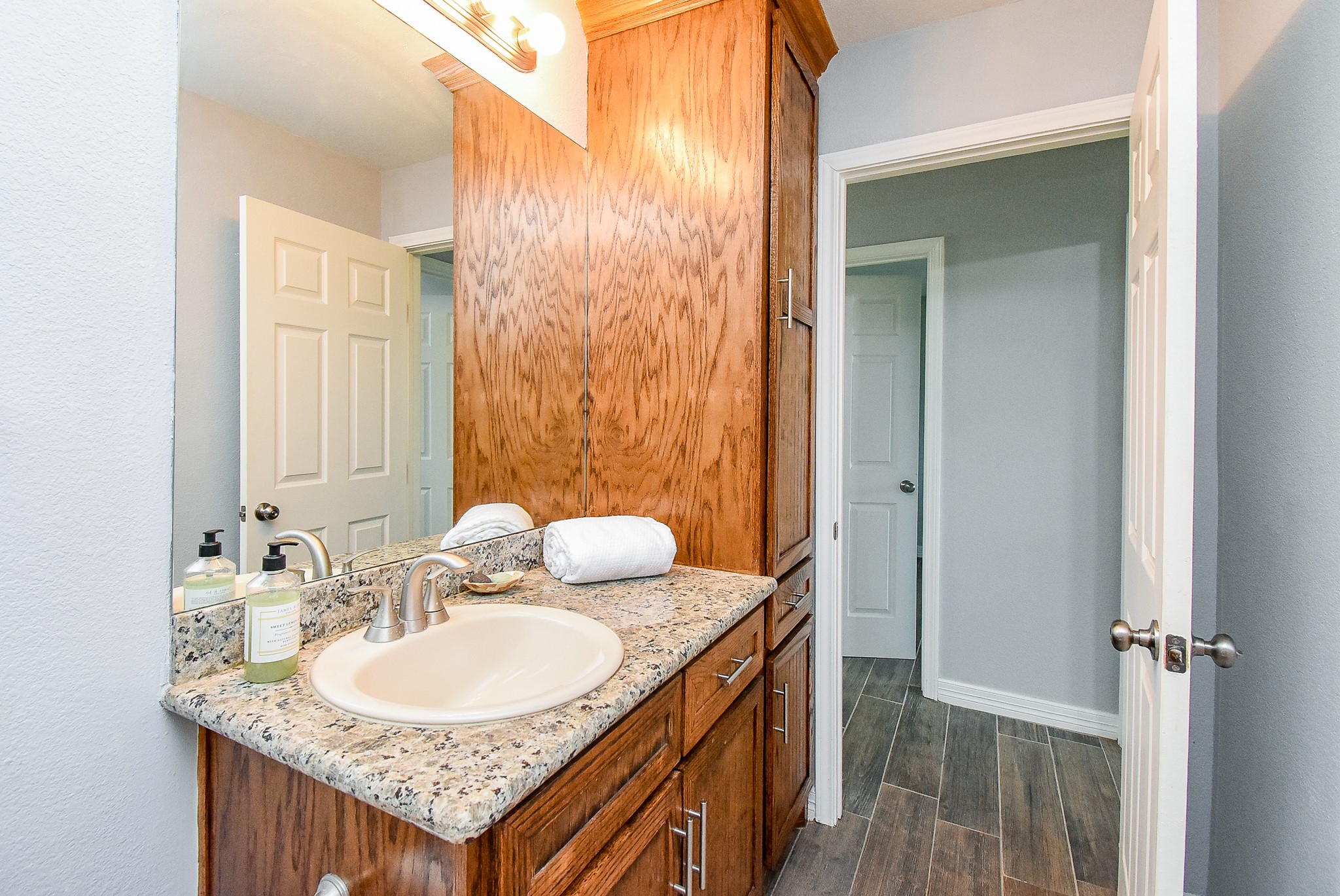 3818 County Road 36 Angleton, TX 77515 - Photo 29 of 49 a bathroom with a granite countertop sink and a mirror