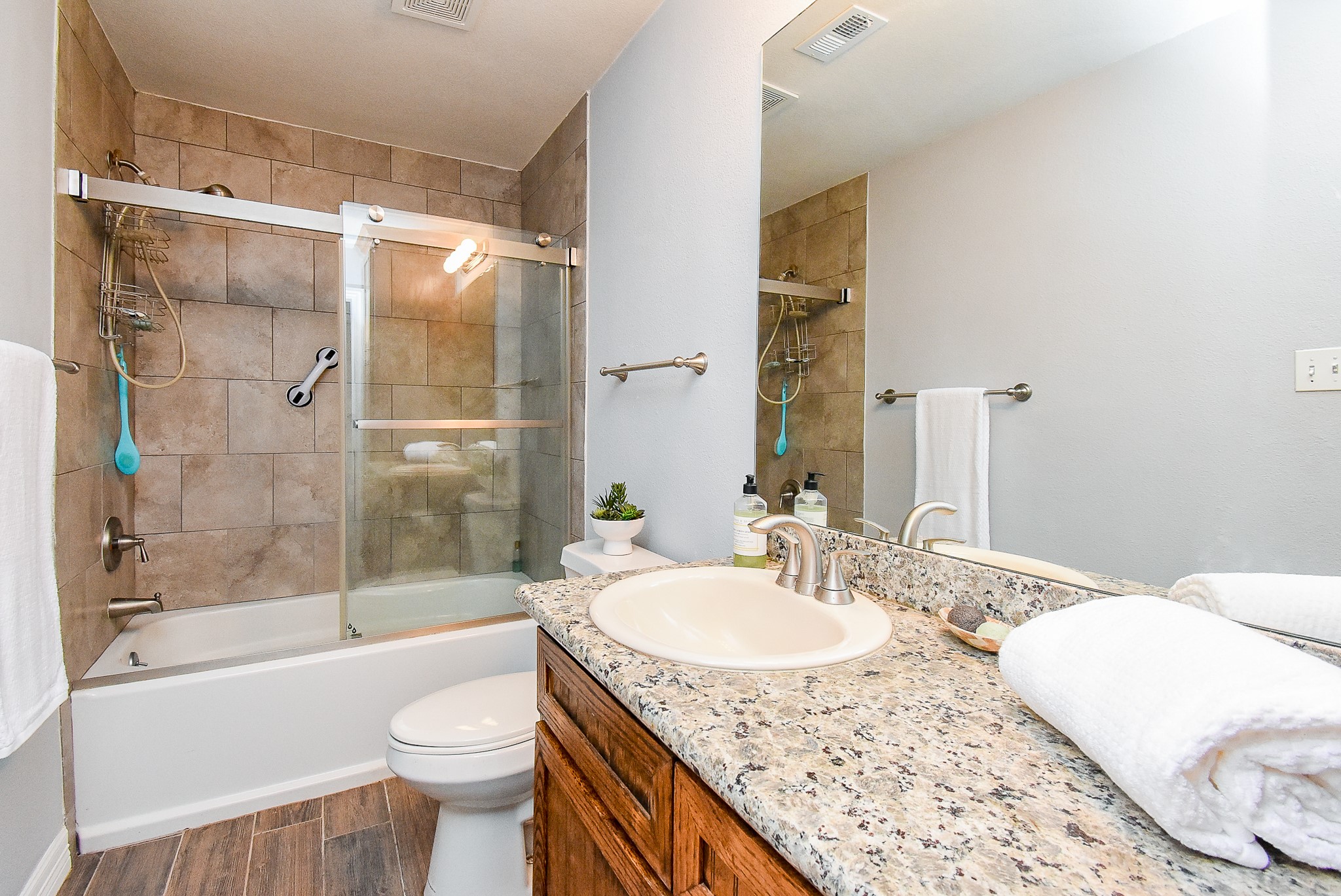 3818 County Road 36 Angleton, TX 77515 - Photo 30 of 49 a bathroom with a granite countertop sink toilet and shower