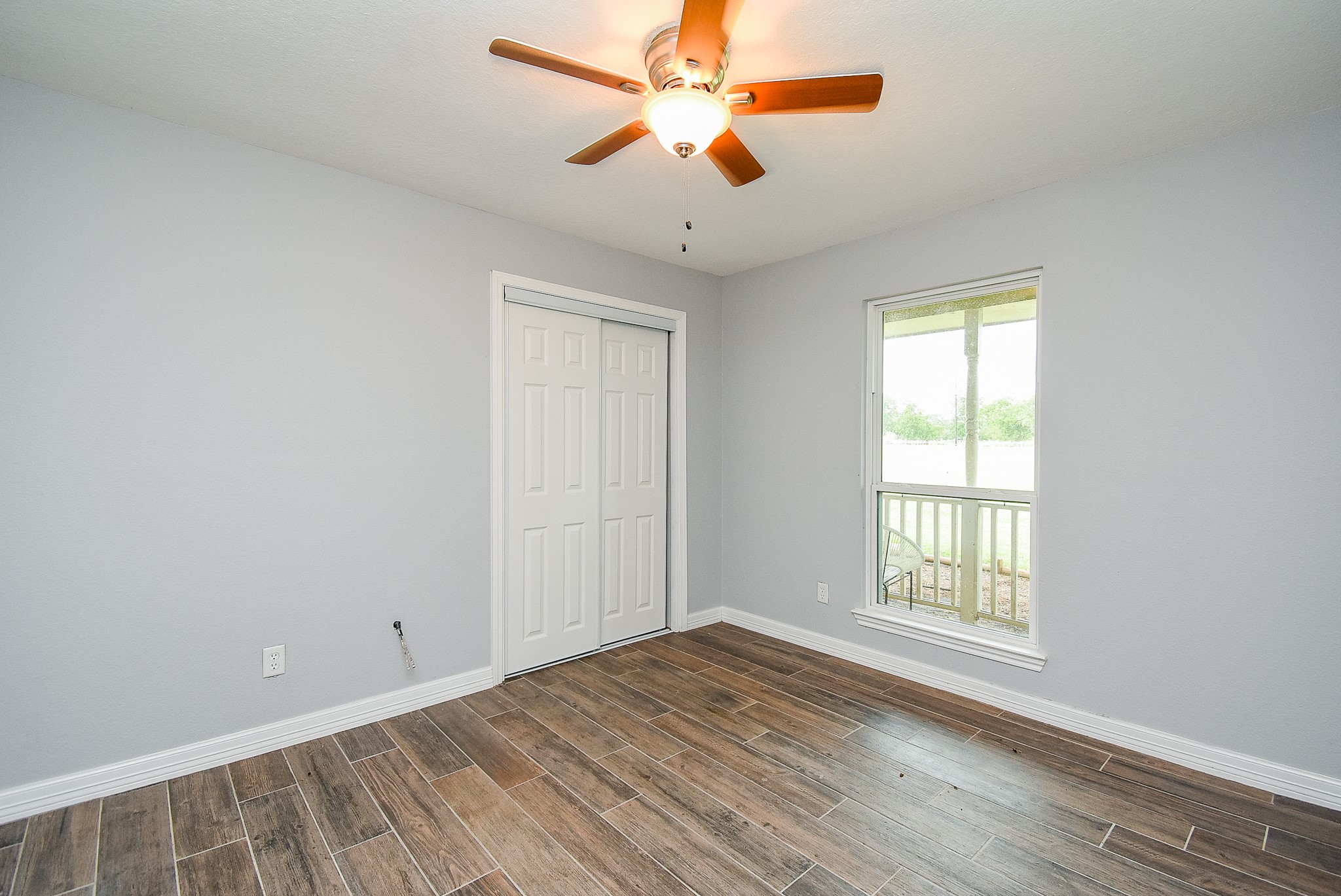 3818 County Road 36 Angleton, TX 77515 - Photo 33 of 49 a view of empty room with wooden floor and fan