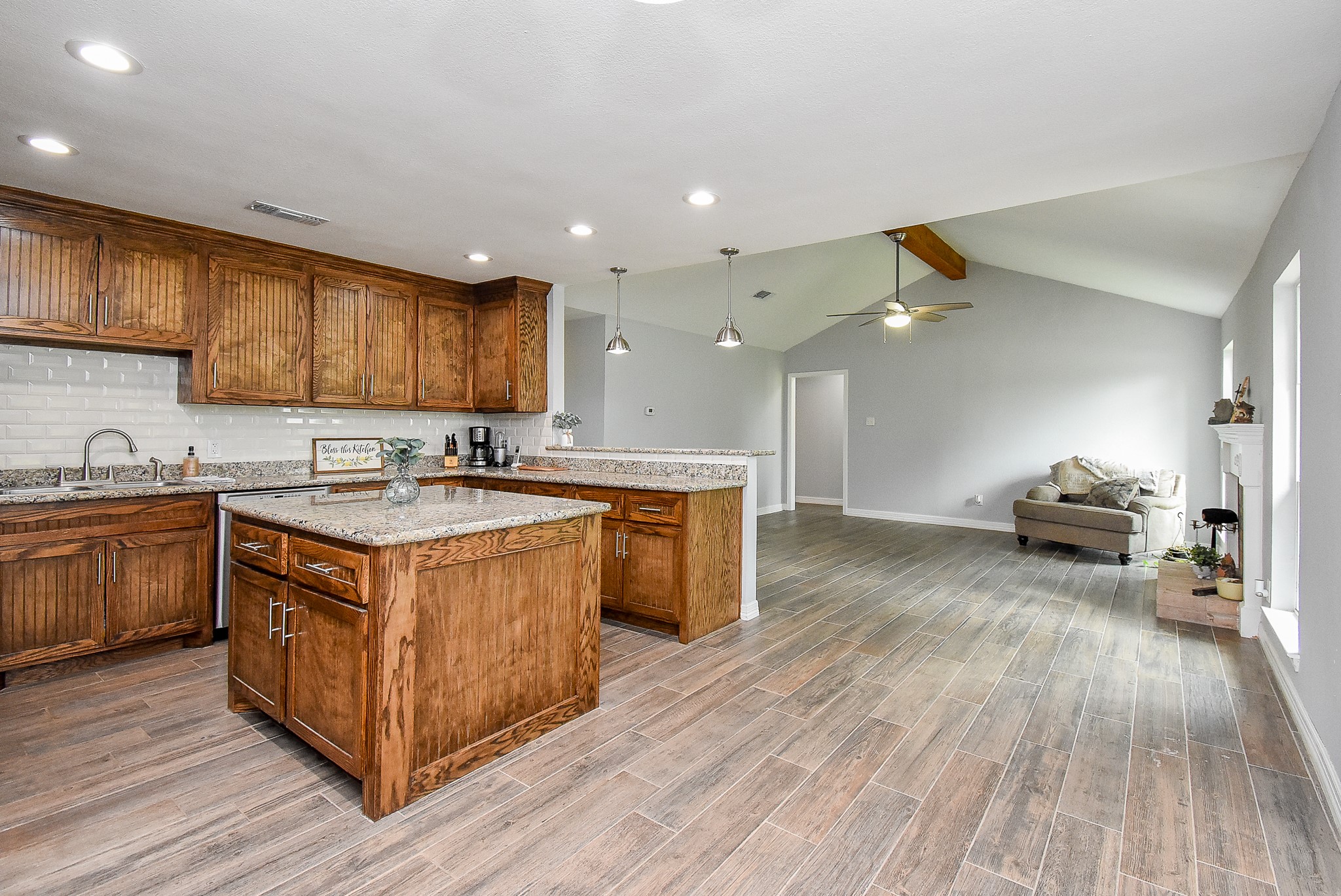 3818 County Road 36 Angleton, TX 77515 - Photo 9 of 49 a kitchen with a sink and wooden cabinets