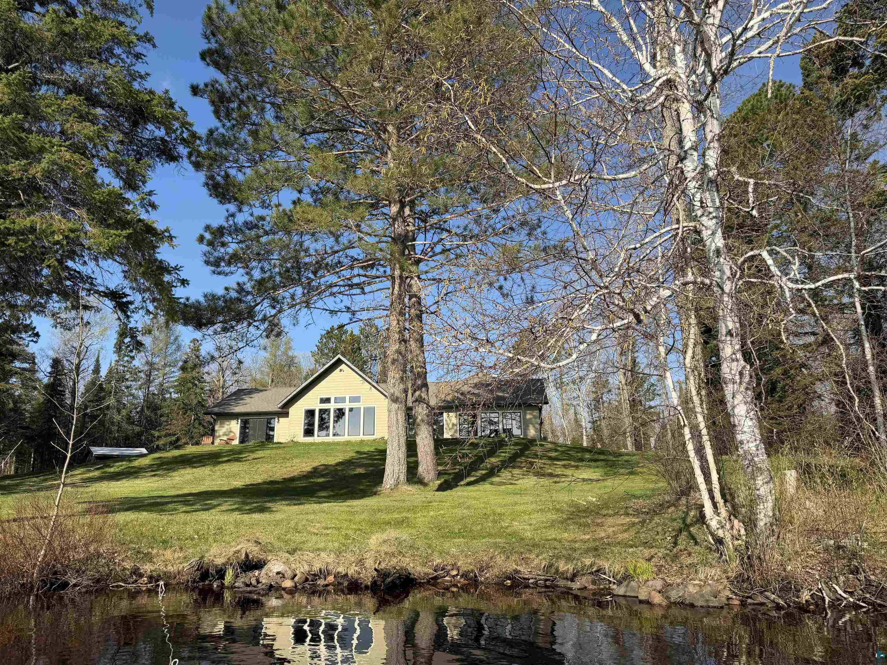 5274 Marble Lake Road Two Harbors, MN 55616 - Photo 53 of 79 Waterfront property featuring a sloped, grassy lawn leading to the water's edge