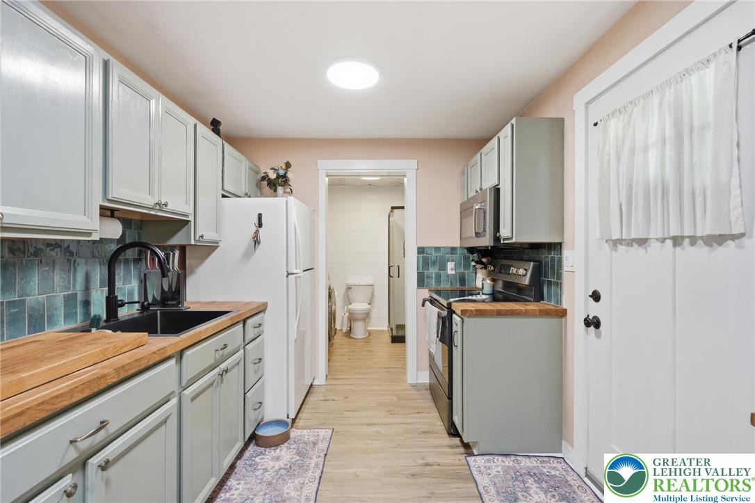 9033 Loop Road Slatington, PA 18080 - Photo 23 of 53 Culinary delights await in this compact yet fully equipped kitchen, boasting durable countertops and sleek appliances.