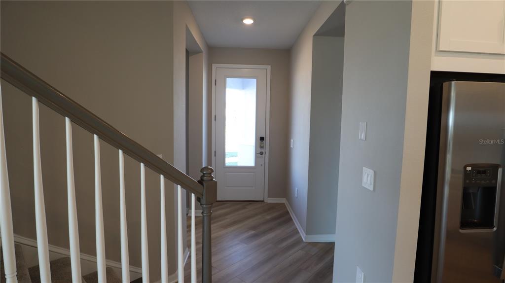 984 Top Minnow Road St. Cloud, FL 34771 - Photo 11 of 31 a view of a hallway with wooden floor and staircase