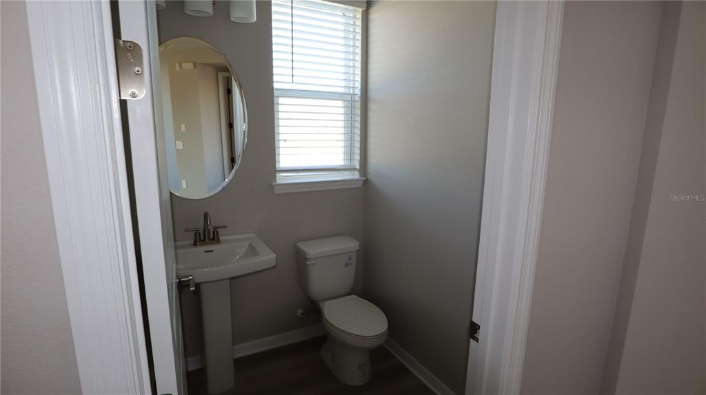 984 Top Minnow Road St. Cloud, FL 34771 - Photo 18 of 31 a bathroom with a toilet sink and mirror