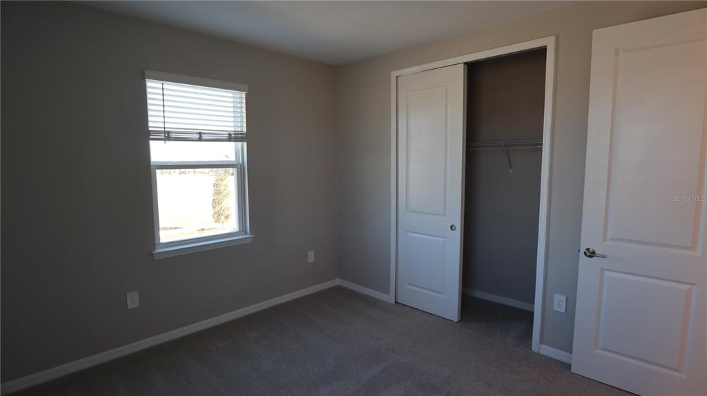 984 Top Minnow Road St. Cloud, FL 34771 - Photo 27 of 31 an empty room with windows and closet
