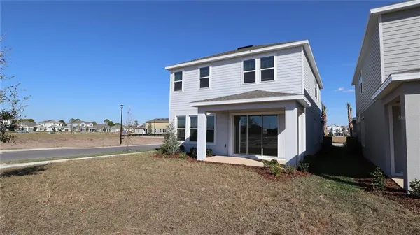 a view of a house with backyard and porch