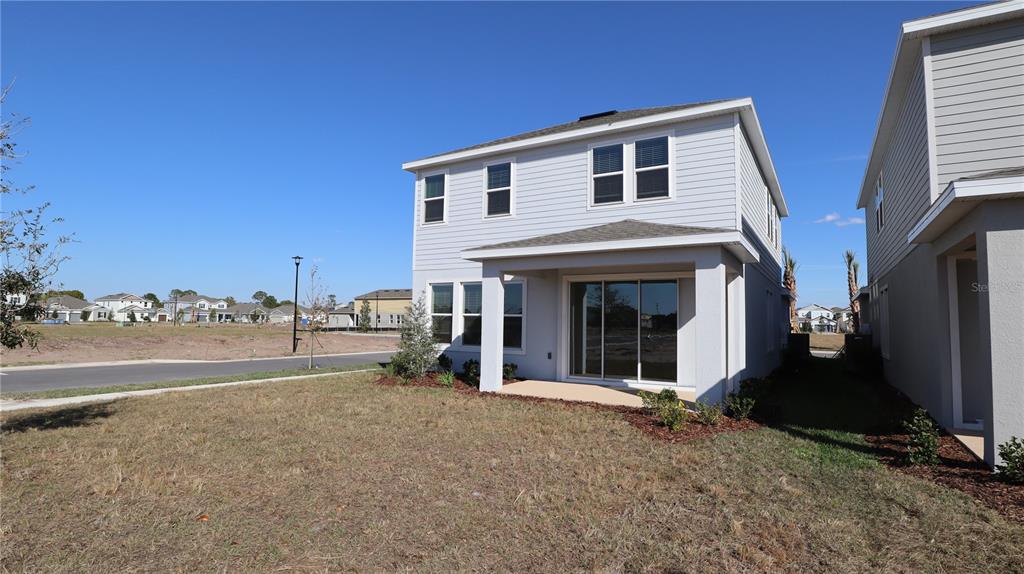 984 Top Minnow Road St. Cloud, FL 34771 - Photo 6 of 31 a view of a house with backyard and porch