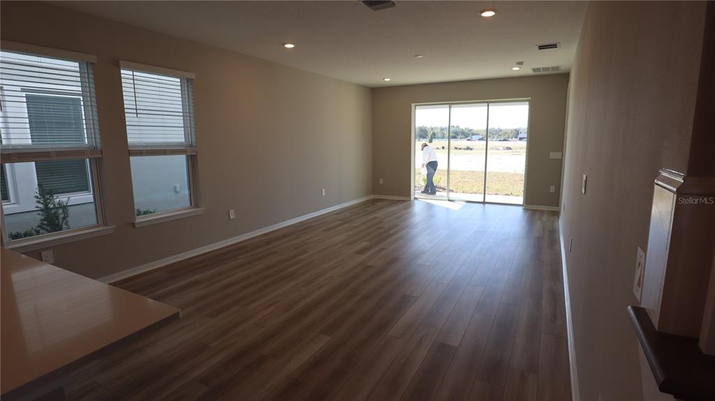 984 Top Minnow Road St. Cloud, FL 34771 - Photo 7 of 31 an empty room with wooden floor and windows