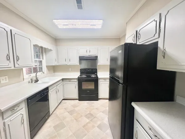 a kitchen with a refrigerator and a sink