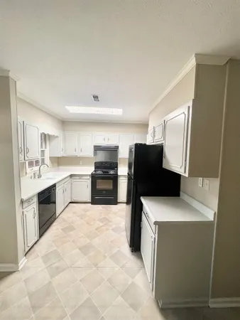 a kitchen with stainless steel appliances kitchen island a white counter top space and cabinets
