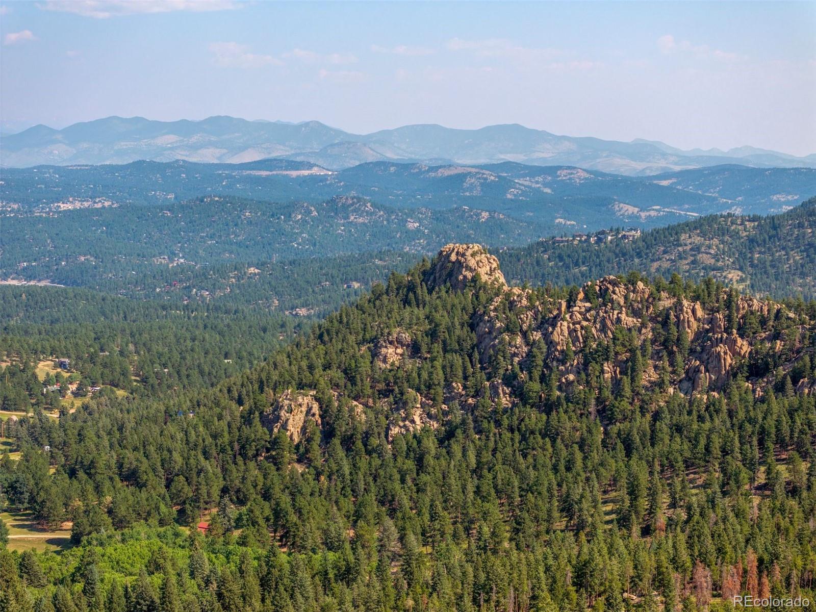 6371 Canyon Creek Road Evergreen, CO 80439 - Photo 28 of 50 a view of a town with mountains in the background
