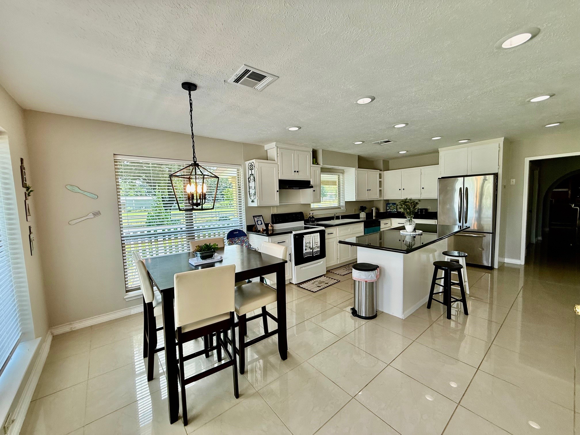 37110 Donigan Road Brookshire, TX 77423 - Photo 23 of 43 a kitchen with a dining table chairs and a view of kitchen