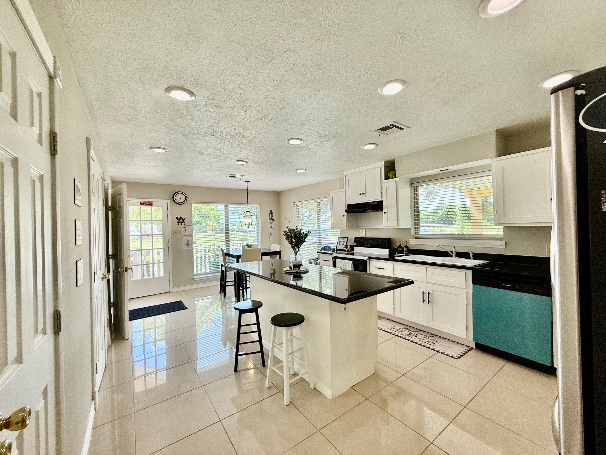 37110 Donigan Road Brookshire, TX 77423 - Photo 24 of 43 a kitchen with stainless steel appliances kitchen island granite countertop a sink and cabinets