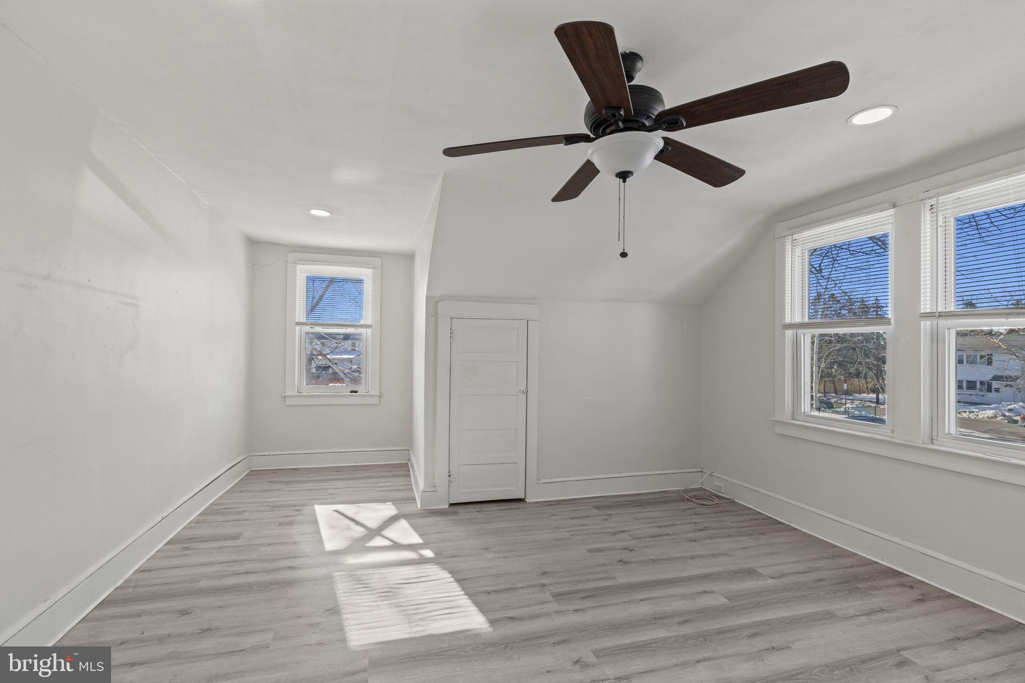 500 Arndt Avenue Riverside, NJ 08075 - Photo 20 of 27 an empty room with wooden floor ceiling fan and windows