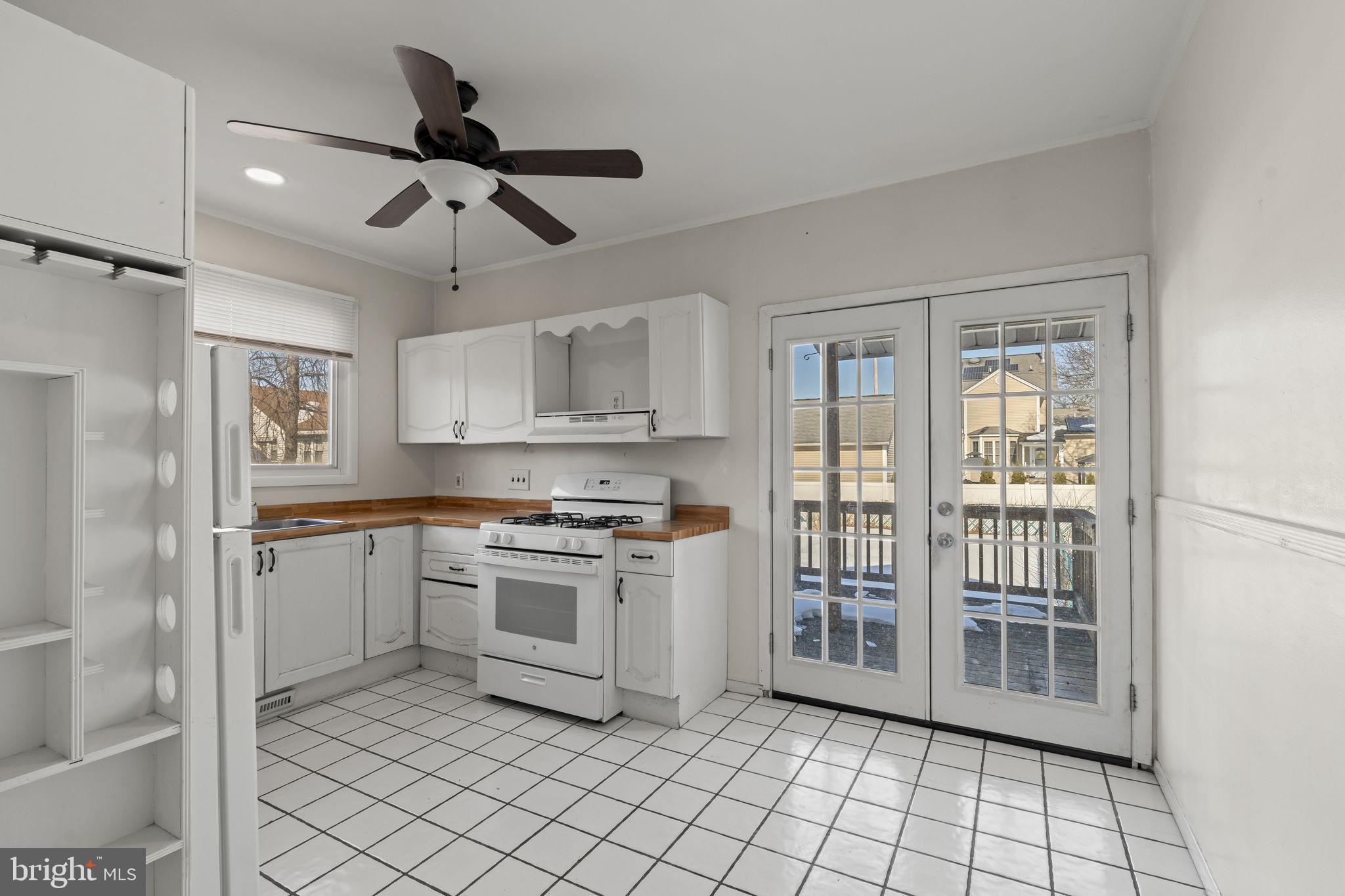 500 Arndt Avenue Riverside, NJ 08075 - Photo 10 of 27 a kitchen with a stove a sink and a refrigerator