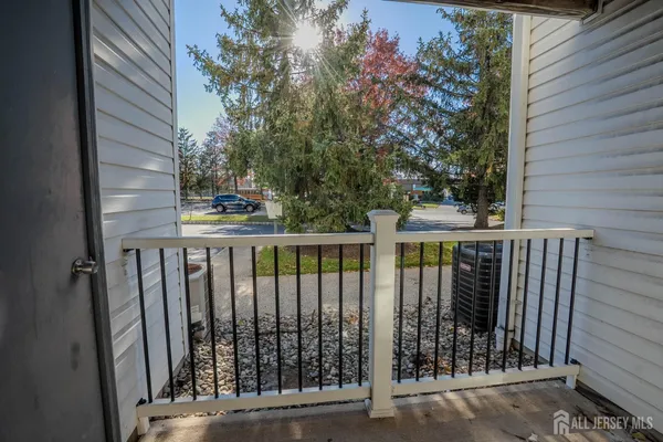 a view of balcony with wooden fence and floor