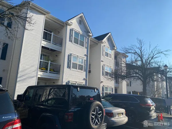 a front view of a house with parking space