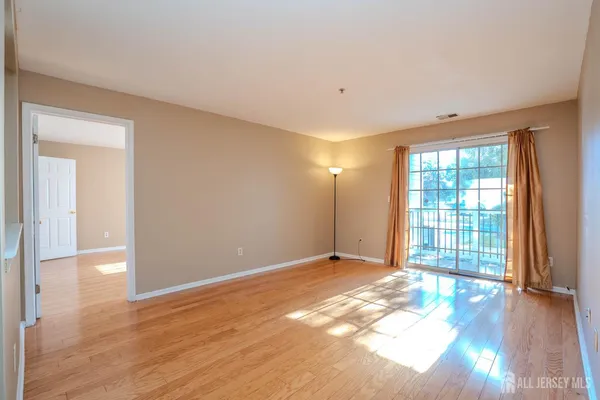 a view of an empty room with glass door