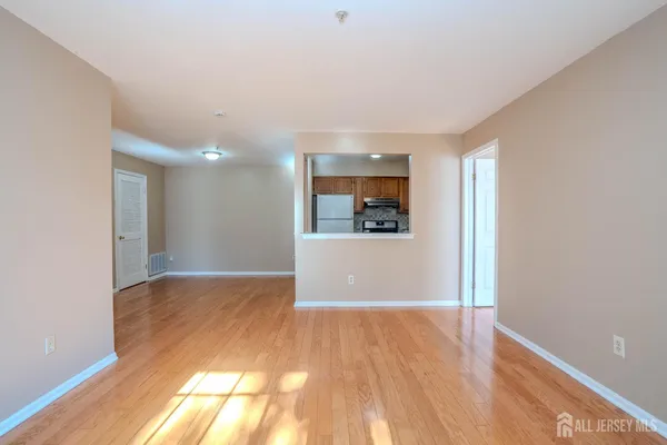 a view of a room with wooden floor and a window